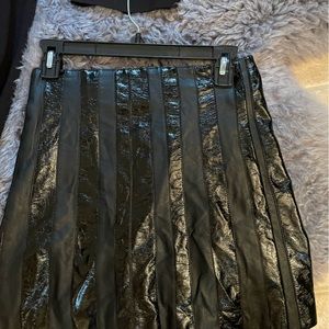 BEBE black skirt with patron leather strips